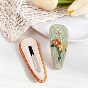 Floral embroidered fabric BB hair clips with light green petals and orange metal snap closure
