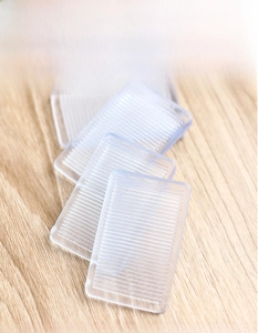 Close-up of clear anti-slip furniture wedges with double-sided gear texture for leveling