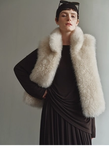 Detailed view of white faux fox fur cashmere vest with plush texture and stand collar