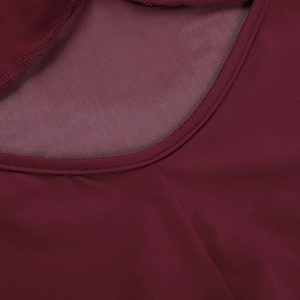 Close-up of burgundy high-waist dress showing sheer mesh patchwork and round neckline