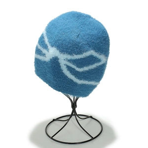 Close-up of plush lake blue beanie featuring soft faux fur and white jacquard pattern
