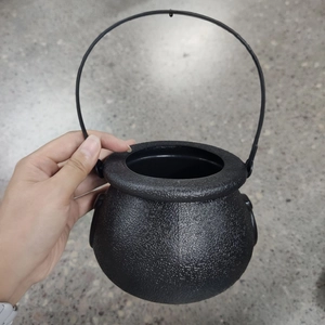 Close-up of black plastic Halloween witch cauldron with textured finish and sturdy handle