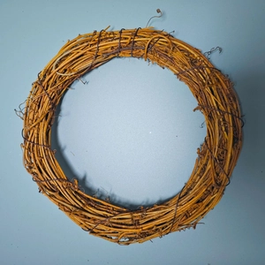 Detail of natural rattan wreath with woven wooden texture for Christmas DIY decor