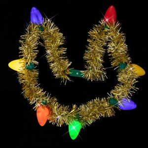 Close-up of golden tinsel Christmas necklace with large colorful glowing light bulbs