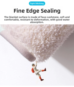 Macro view of white faux cashmere floral bath mat showing tight stitching and soft texture