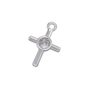 Macro detail of silver cross pendant with central clear zircon and polished finish