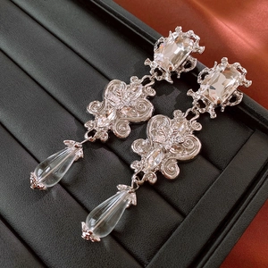 Baroque drop earring detail with square crystal and teardrop pendant on black leather box