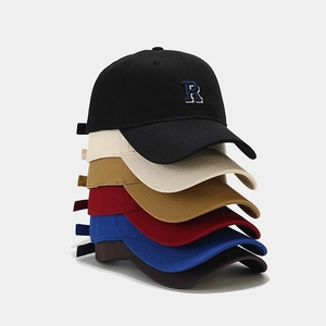 Multiple colors of baseball caps with R embroidery stacked in a vertical layout