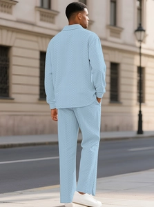 Detail of light blue knit polo set featuring 3D geometric texture and long sleeves