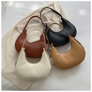 Detail view of four minimalist baguette bags in white, brown, black and beige colors