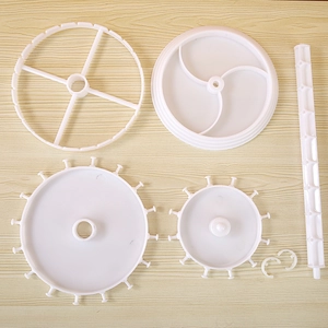 Rotating white jewelry organizer stand set with multiple hooks and tiered storage trays