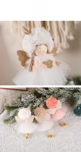 Detail of plush Christmas angel ornaments with glitter antlers, wings, and gold metal bells