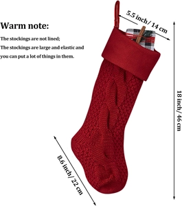 Detail view of 18-inch red cable knit Christmas stocking with size labels on white background
