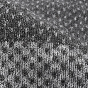Détail d'un bonnet en maille bicolore épaisse en laine texturée gris et noir
