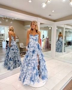 Detail of blue floral corset evening dress with ruffled high slit and lace design