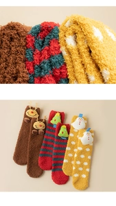 Detailed close-up of thick coral fleece Christmas socks with soft 3D cartoon plush dolls