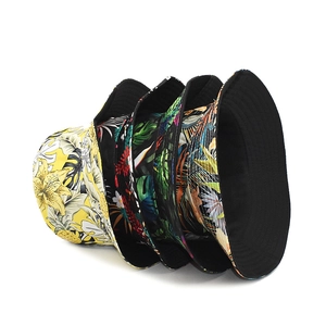 Detailed stack of diverse tropical floral prints and solid cotton bucket hats for summer
