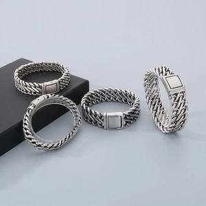 Detailed macro view of retro stainless steel biker chain bracelets with matte metal clasps