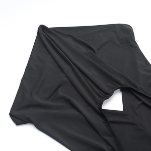 Detail view of the black elastic knitted fabric and backless cutout design on the dress