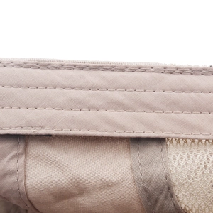 Macro detail of breathable mesh fabric and reinforced double stitching on beige flat cap