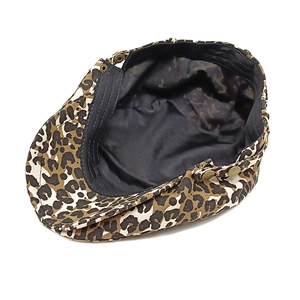 Detail view of newsboy cap featuring leopard print canvas and vintage bronze metal snap button