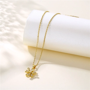 French style gold flower pendant necklace with zircon petals on white cylinder stand