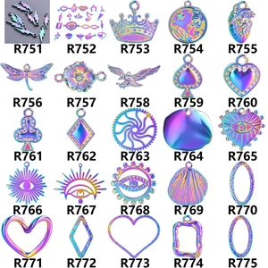 Detailed macro grid of iridescent alloy charms featuring heart and wing designs