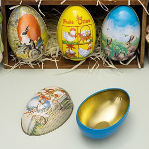 Detailed view of open Easter egg tin with golden interior and rabbit illustration