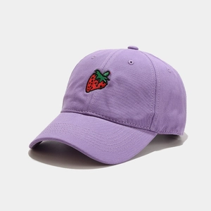 Purple cotton baseball cap with red strawberry embroidery viewed from a 45-degree angle