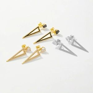 Macro detail of S925 silver geometric triangle studs with black and white zircon stones