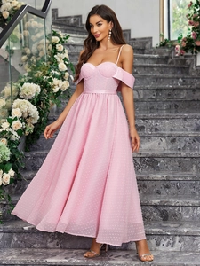 Elegant pink off-shoulder evening gown with polka dot pattern and a full pleated skirt