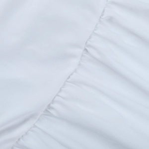 Close-up of white lightweight knit fabric with detailed smocking and gathered texture