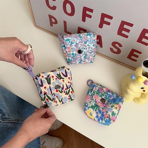 Detail of floral mini cotton pouches with metal snap buttons and portable wrist straps
