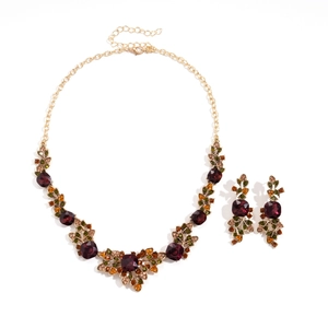Vintage gold jewelry set with deep red crystal leaf pendants and matching earrings