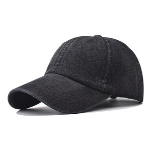 Close-up of the vintage washed dark gray denim fabric texture and seams on a baseball cap