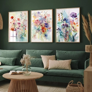 Modern Nordic watercolor floral triptych framed wall art set above a green sofa