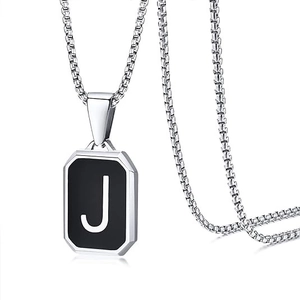Detailed view of silver box chain necklace with square black pendant and letter J