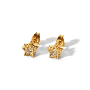 Macro shot of 18K gold star earrings with tiny sparkling diamonds on white background