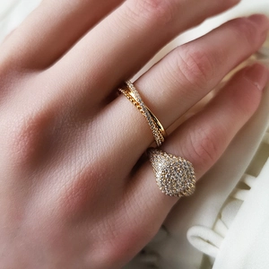 Macro shot of layered 18K gold S925 rings with micro-pave white zircon stones