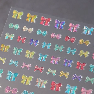 Self-adhesive laser glitter bow nail art stickers with 3D embossed colorful designs