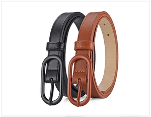 Detail of leather belts with oval buckles in black and brown over white background