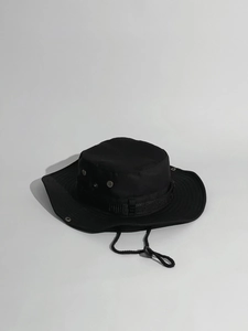 Close-up of black boonie hat showing metal ventilation eyelets and snap button detail