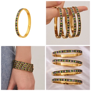 Detailed macro of gold-plated stainless steel bangles with colorful square-cut zircons