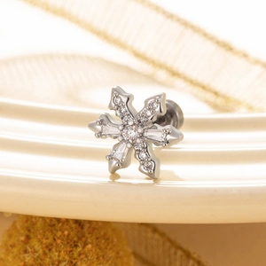 Elegant silver snowflake stud earrings with sparkling zircon stones in a macro view