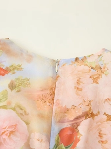 Detail of floral printed dress neckline featuring a seamless invisible zipper closure