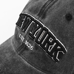 Close-up of 3D embroidery detail on washed cotton denim vintage baseball cap