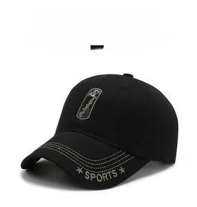 Detail of black baseball cap featuring yellow brim stitching and sports embroidery