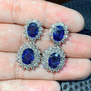 Dettaglio di orecchini in zircone blu reale con halo scintillante e finitura in argento