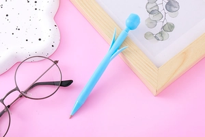 Close-up of light blue tulip-shaped mechanical pencil on a decorative pink background