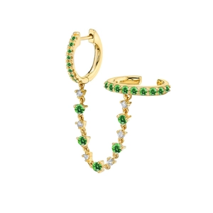 Detailed shot of golden double piercing chain earring with green crystals and small white stones